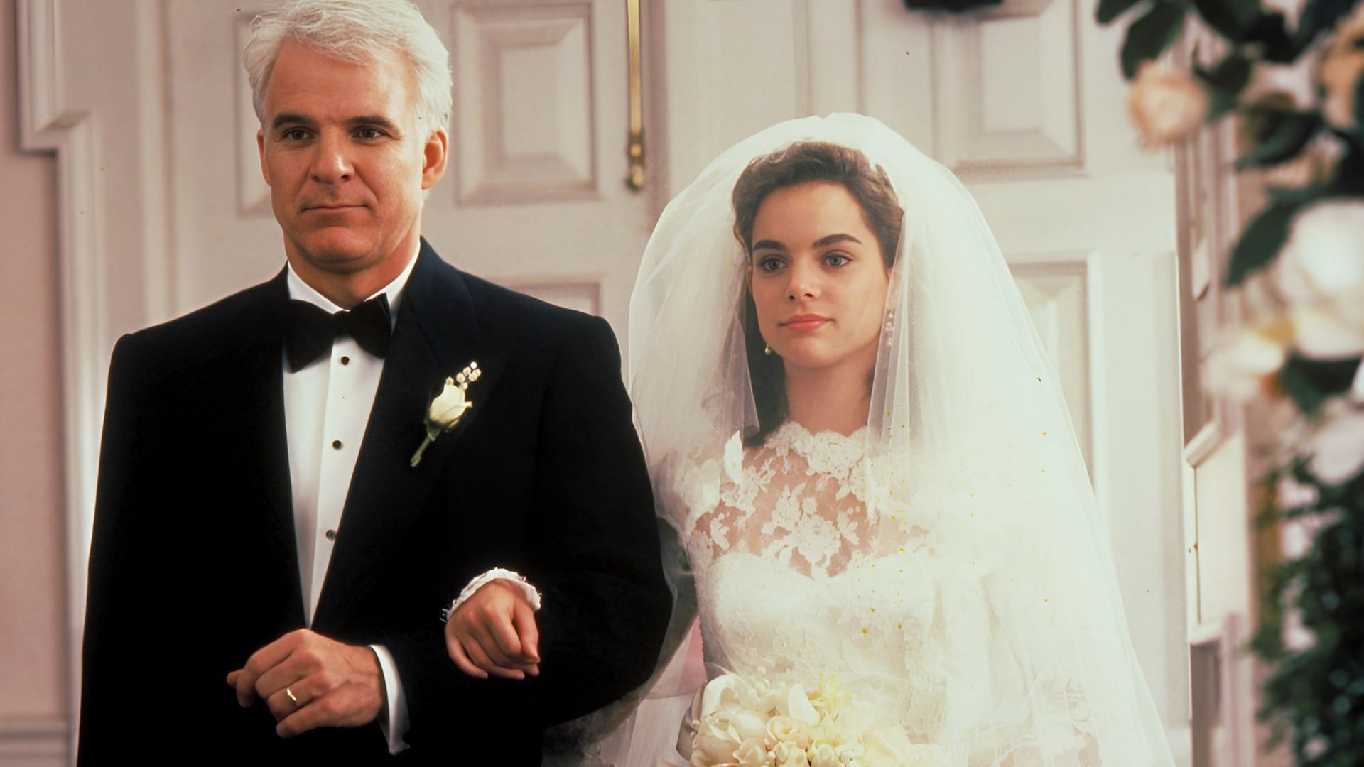 Steve Martin as George Banks walks Annie Banks down the aisle in Father of the Bride (1991), capturing the emotional heart of the film (Image via Disney+)